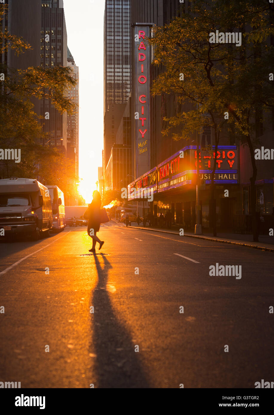 USA, New York, Street with pedestrians at sunset Stock Photo