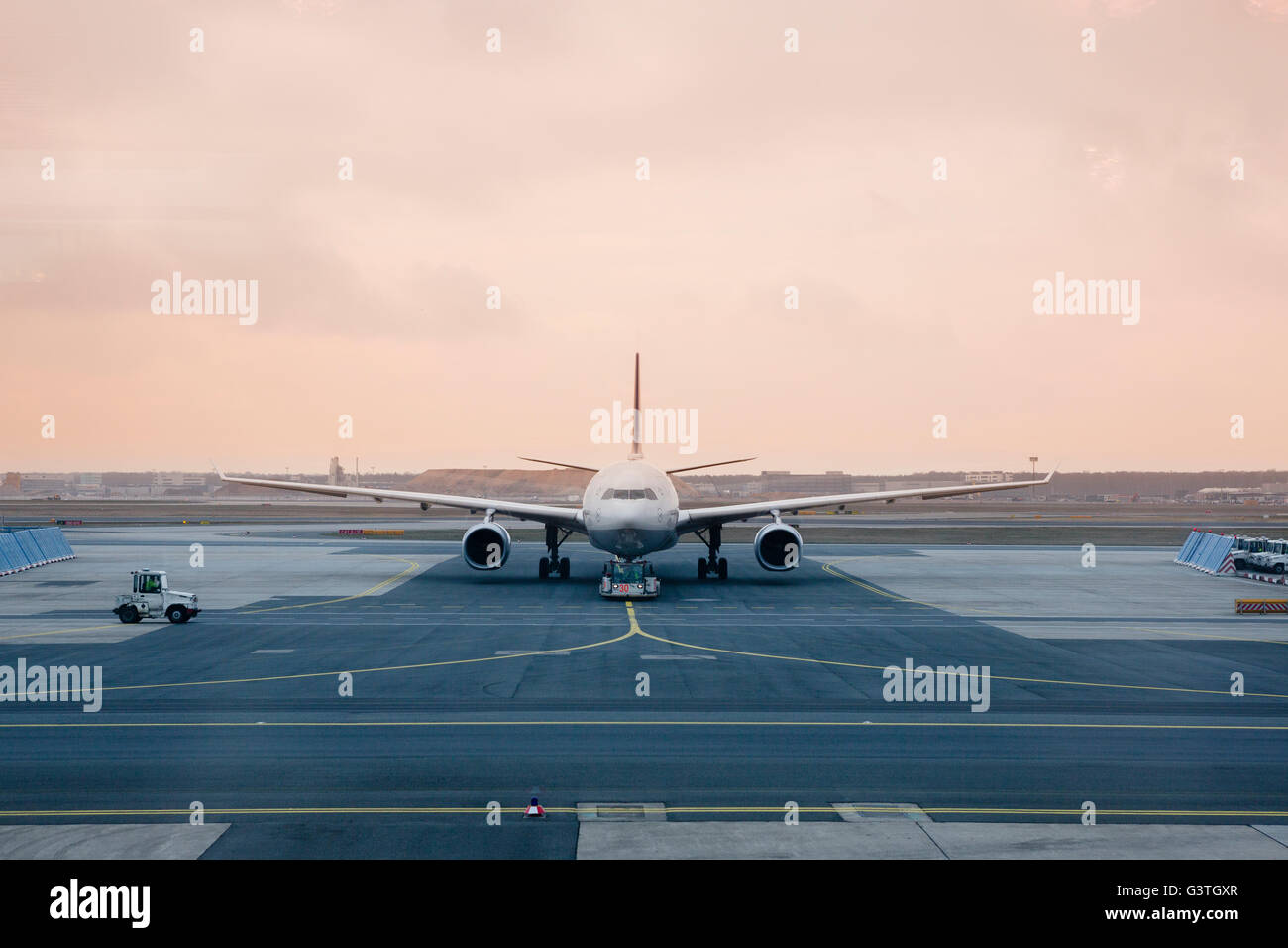 Germany, Frankfurt, Airplane on runway at dusk Stock Photo