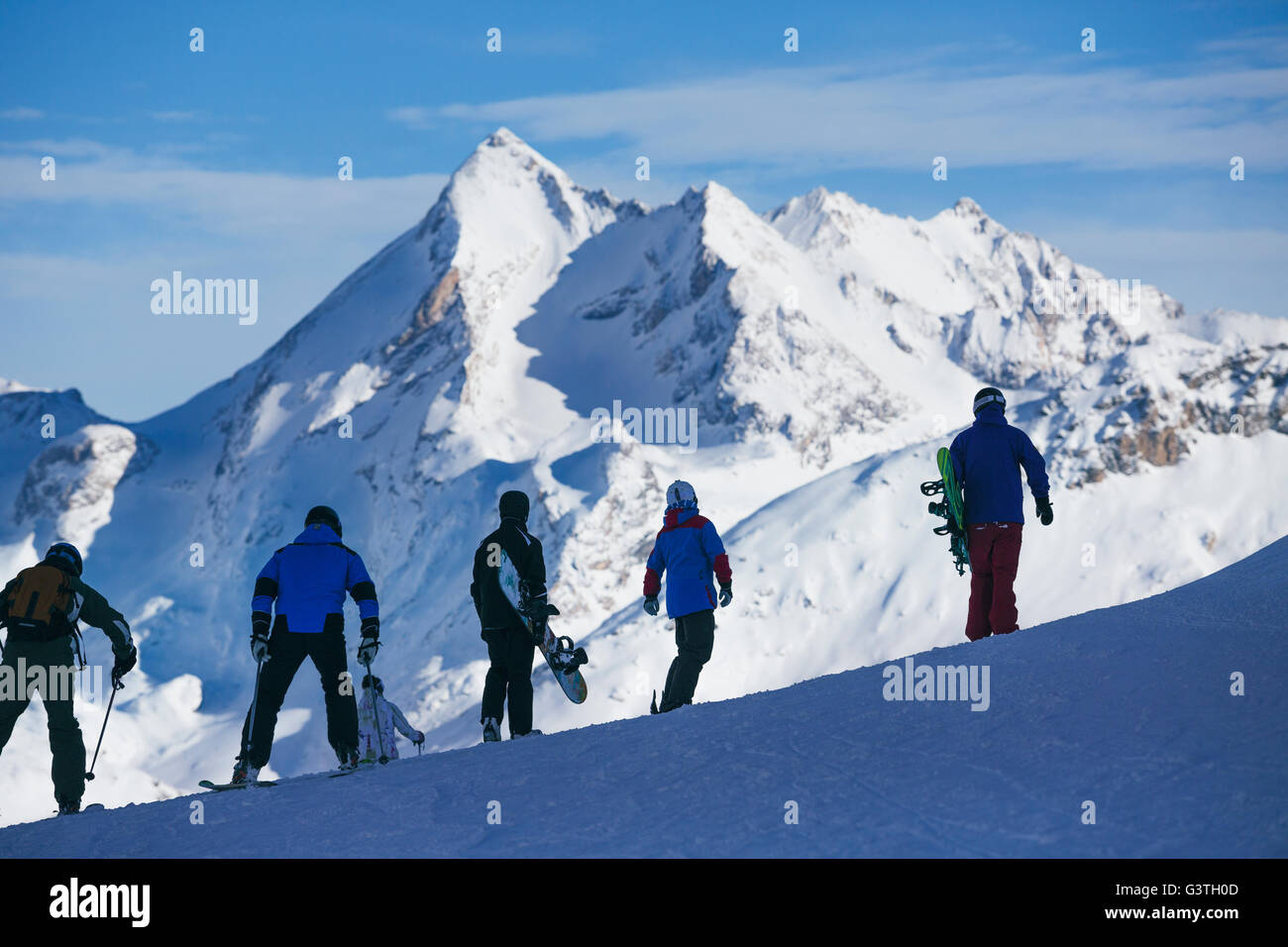 France, Rhône-Alpes, Savoie, Val D'Isere, People skiing and snowboarding in mountains Stock Photo