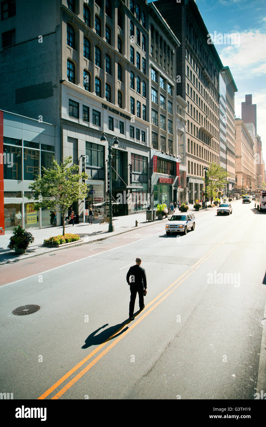 USA, New York State, New York City, Man walking down street Stock Photo