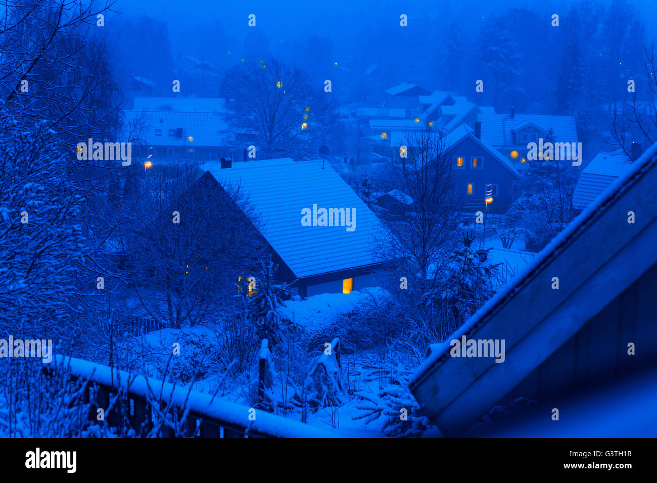 Sweden, Tyreso, Trollbacken, Snow covered houses at night Stock Photo