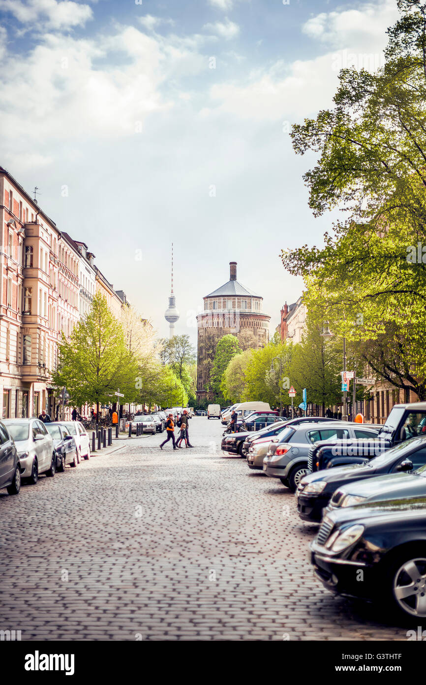 Germany, Berlin, Prenzlauer Berg, View along cobblestone street with parked cars Stock Photo