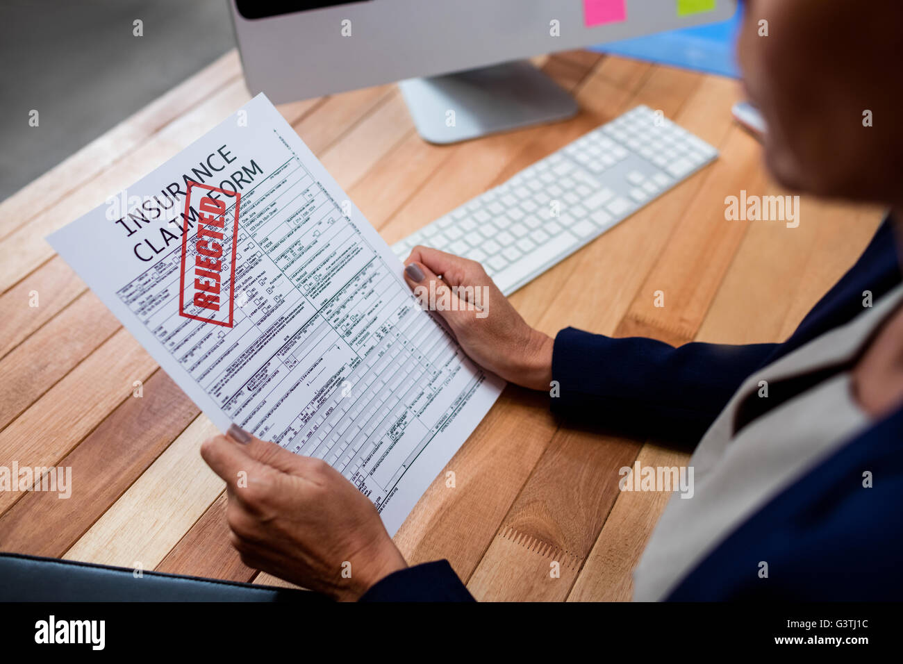 People reading an insurance claim form Stock Photo