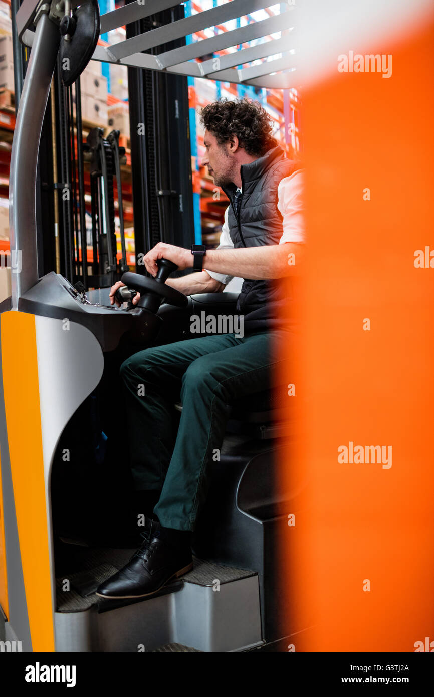 Warehouse manager using a forklift Stock Photo