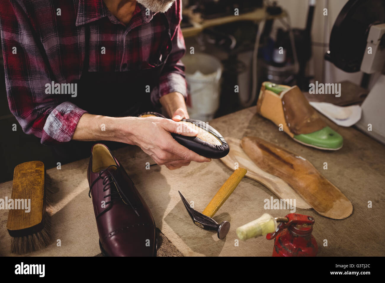 Cobbler holding a shoe Stock Photo Alamy