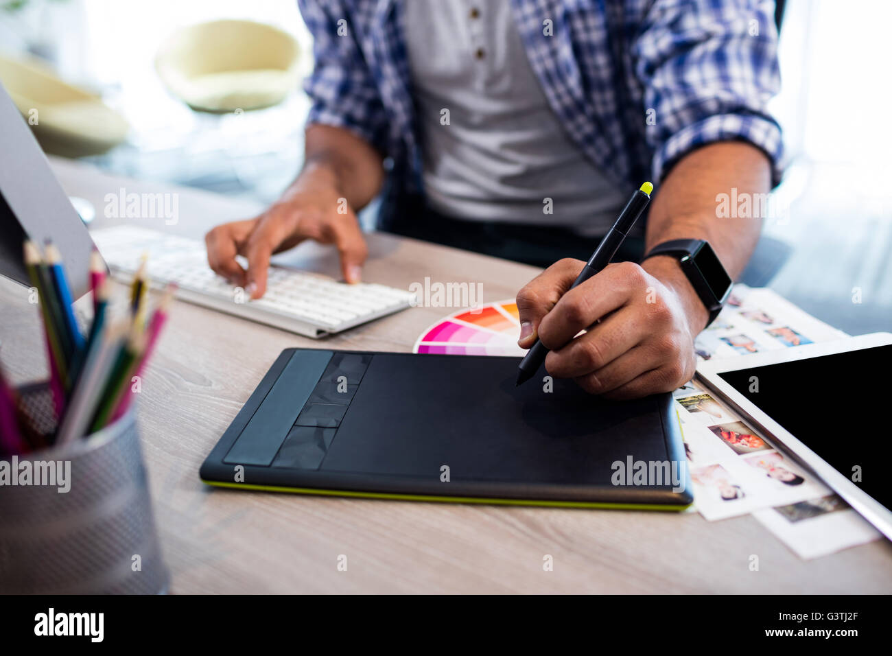 Close up view of hands working on digital tablet Stock Photo - Alamy