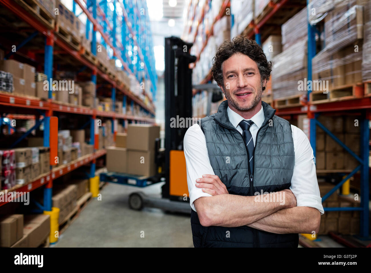 Warehouse manager front of forklift Stock Photo