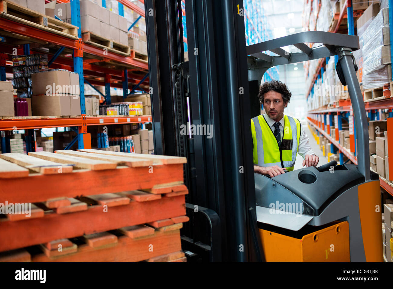 Warehouse manager using a forklift Stock Photo