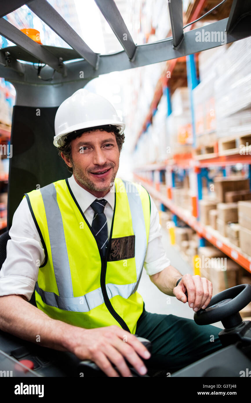 Portrait of a warehouse manager using a forklift Stock Photo