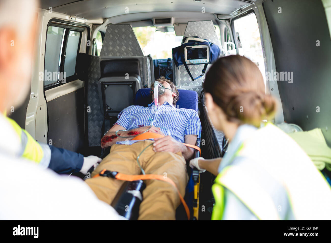 Injured man with ambulance men Stock Photo Alamy