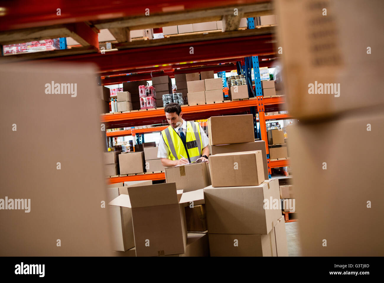 Warehouse manager checking boxes Stock Photo