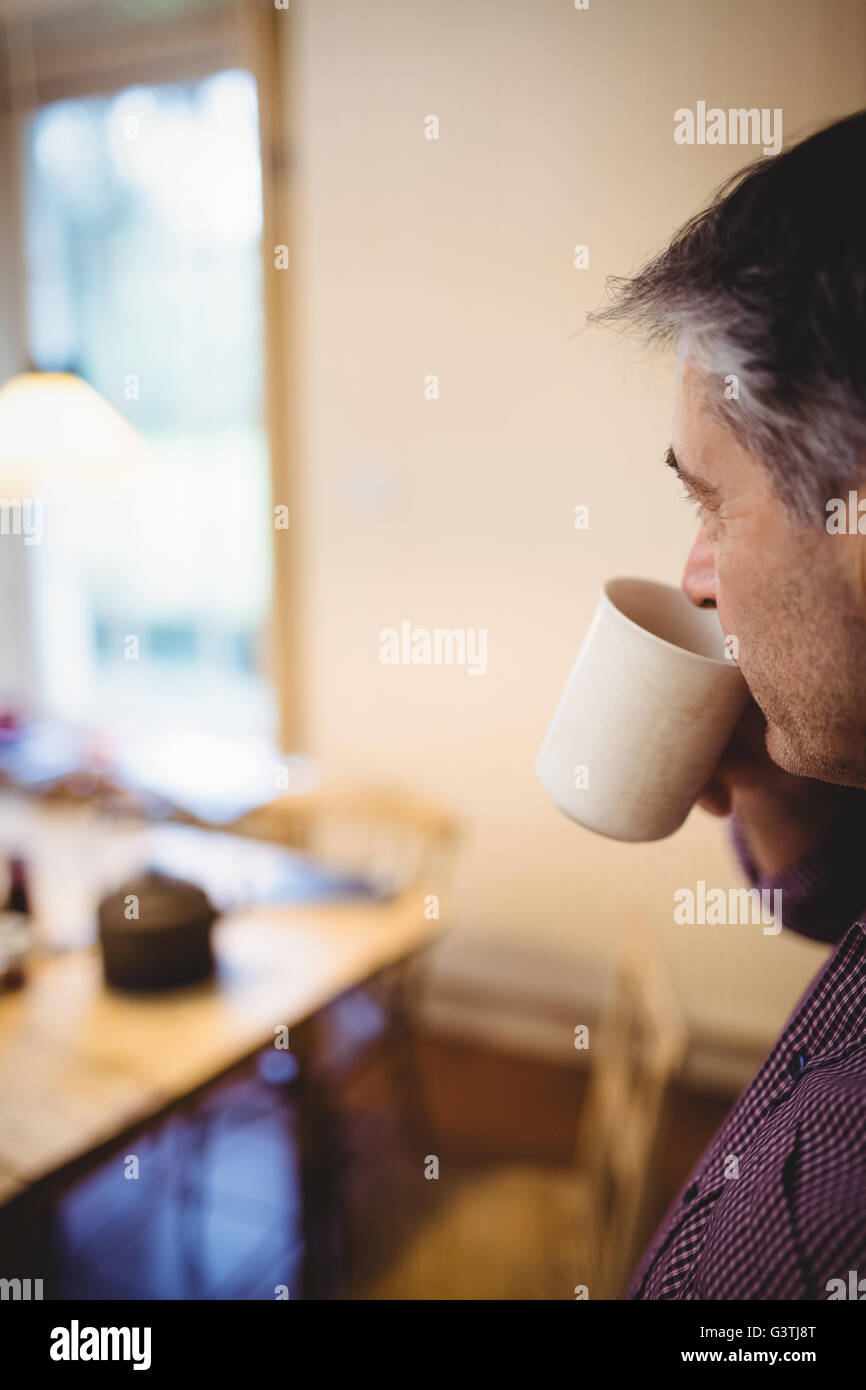 Mature man sipping hot drink Stock Photo