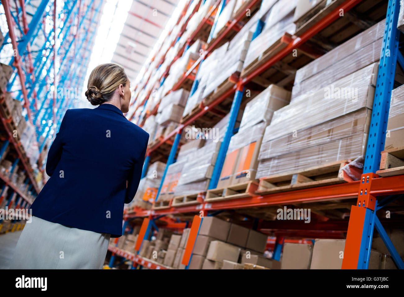 Low angle view of warehouse manager walking and looking up Stock Photo