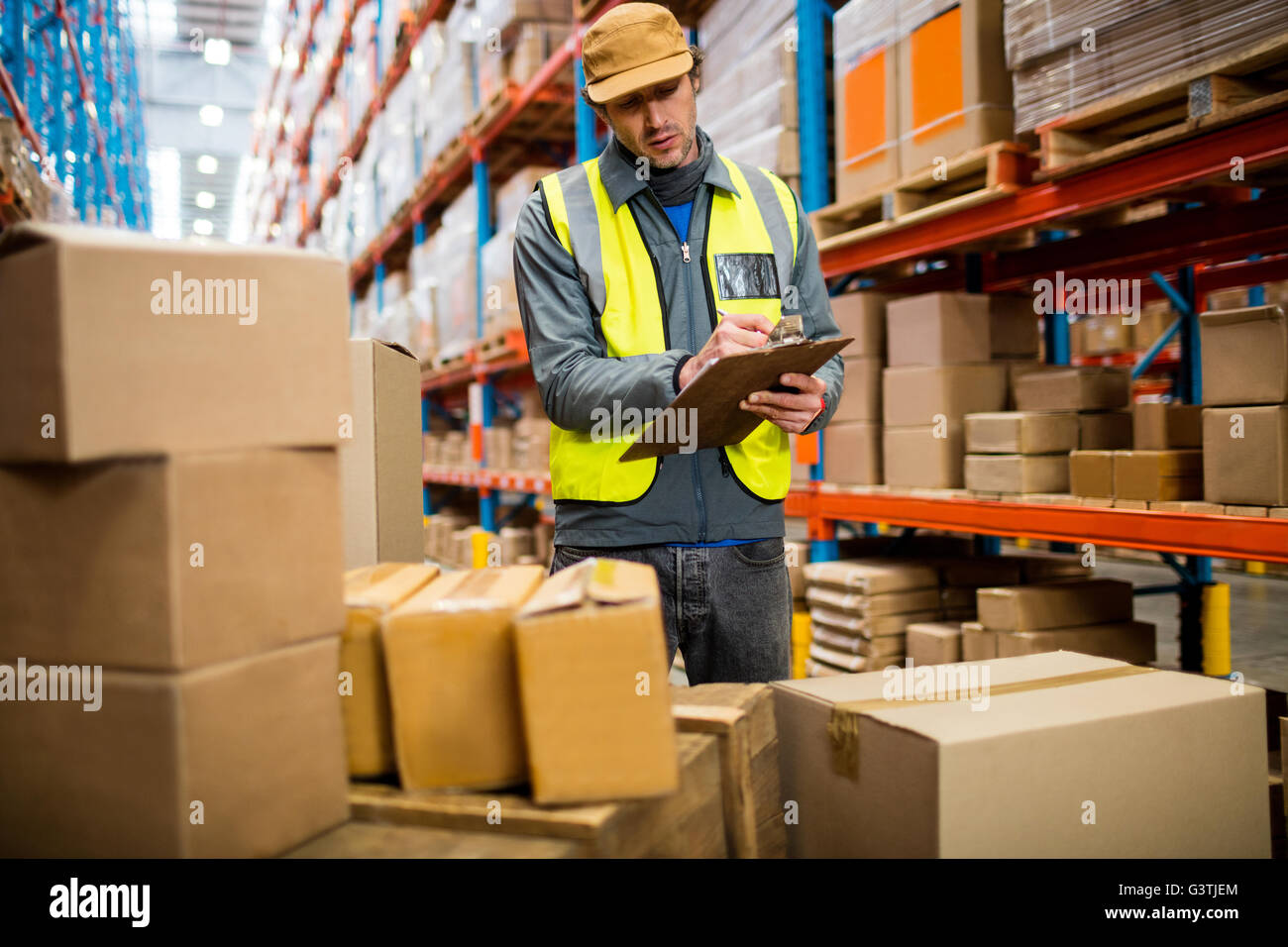 Worker writing on his clipboard Stock Photo - Alamy