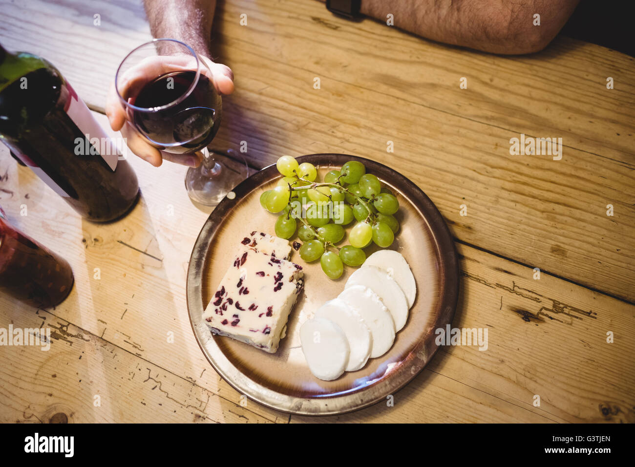 Close up view of red wine glass and cheeses Stock Photo