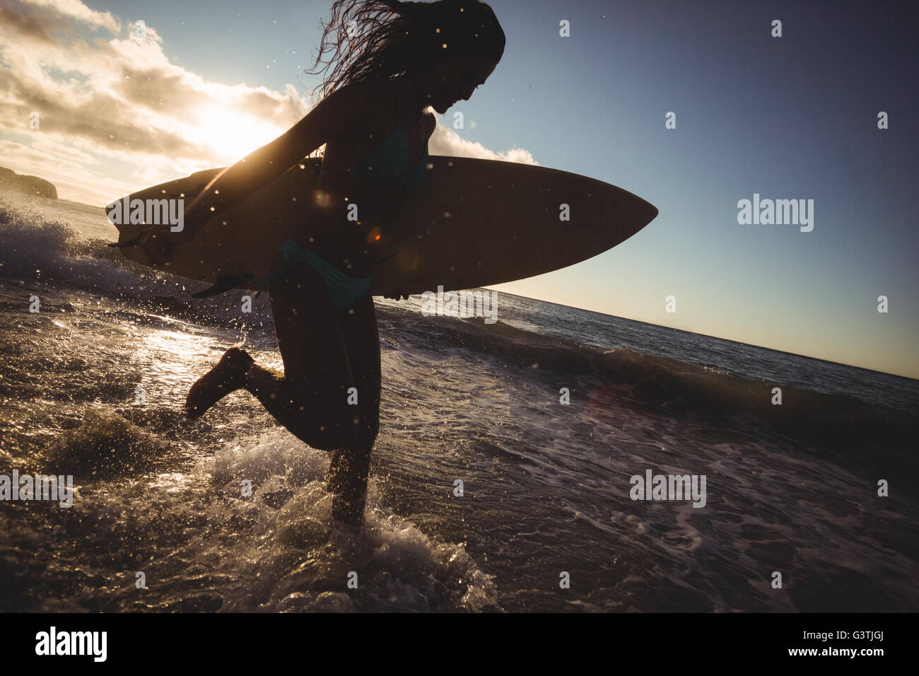 Woman running on the beach Stock Photo