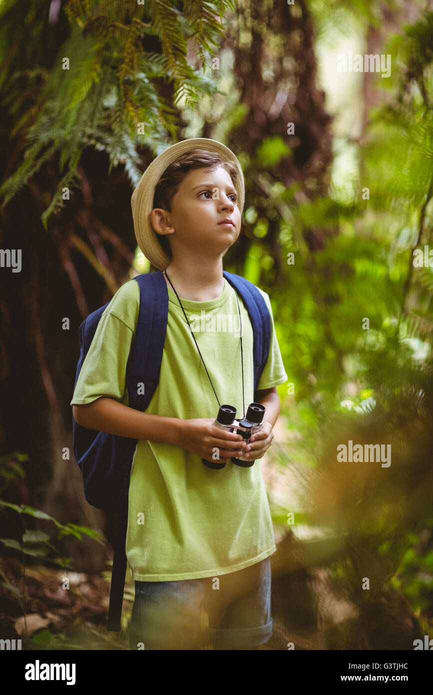 Young boy holding binoculars Stock Photo