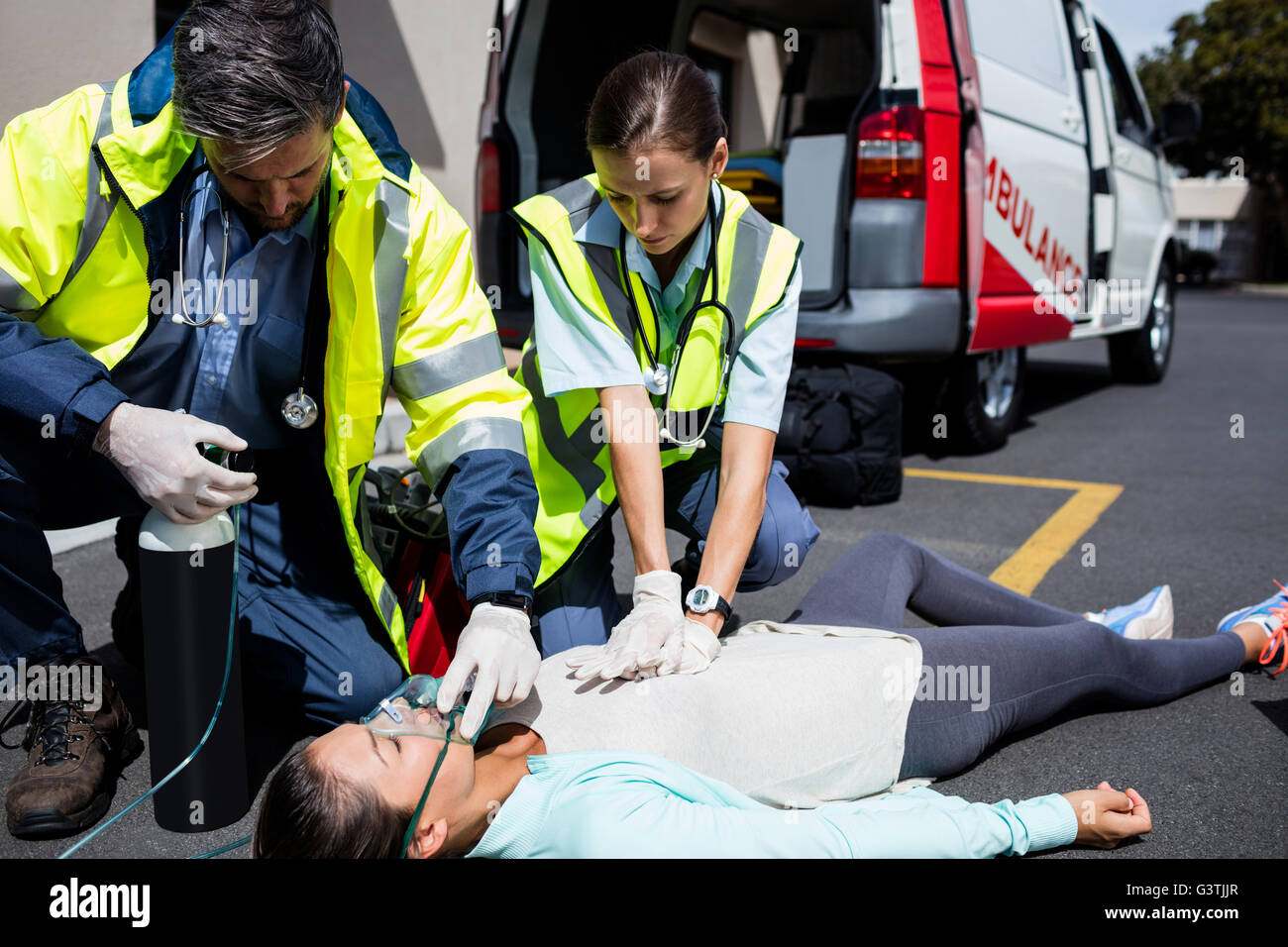 Ambulance men taking care of injured people Stock Photo