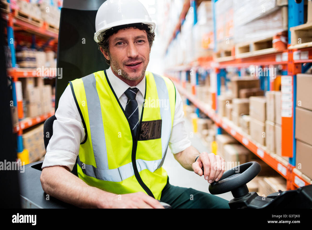 Portrait of a warehouse manager using a forklift Stock Photo