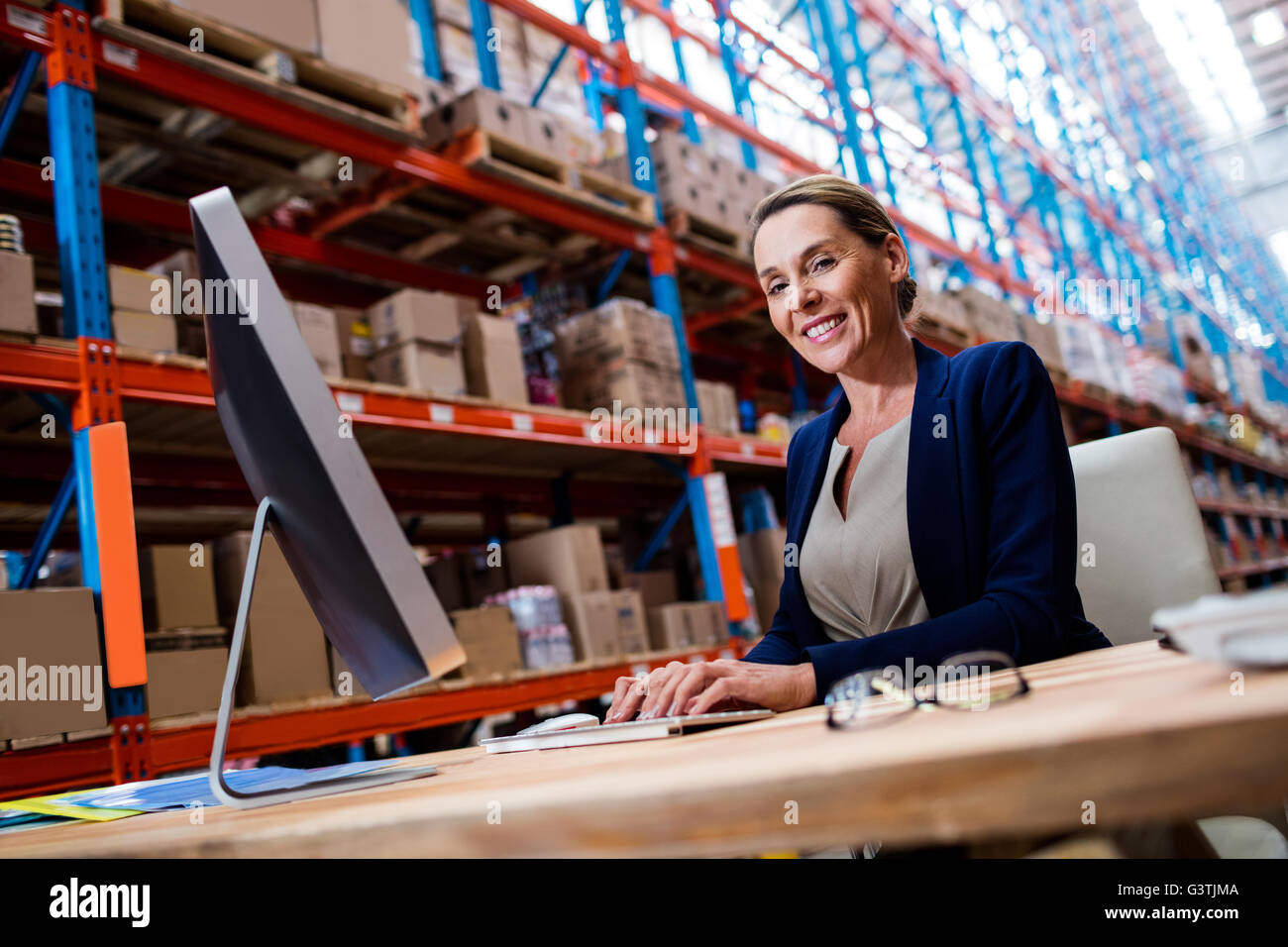 Warehouse manager using a laptop Stock Photo
