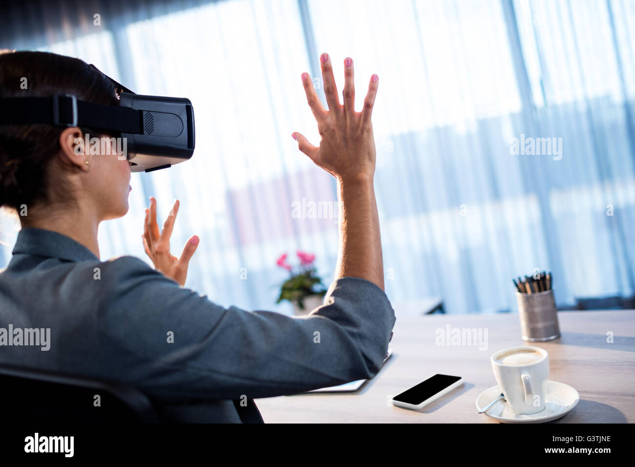 Businesswoman using an oculus Stock Photo