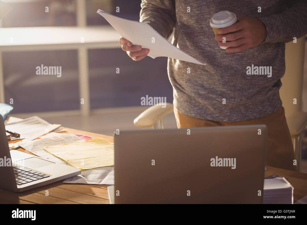 Hipster reading documents Stock Photo