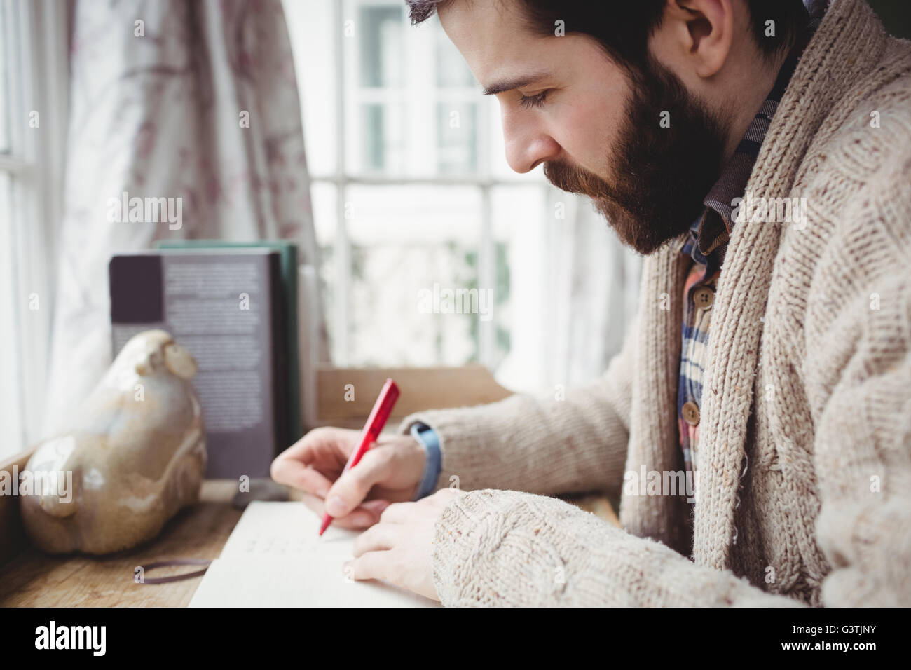 Profile of man writing in a notebook Stock Photo