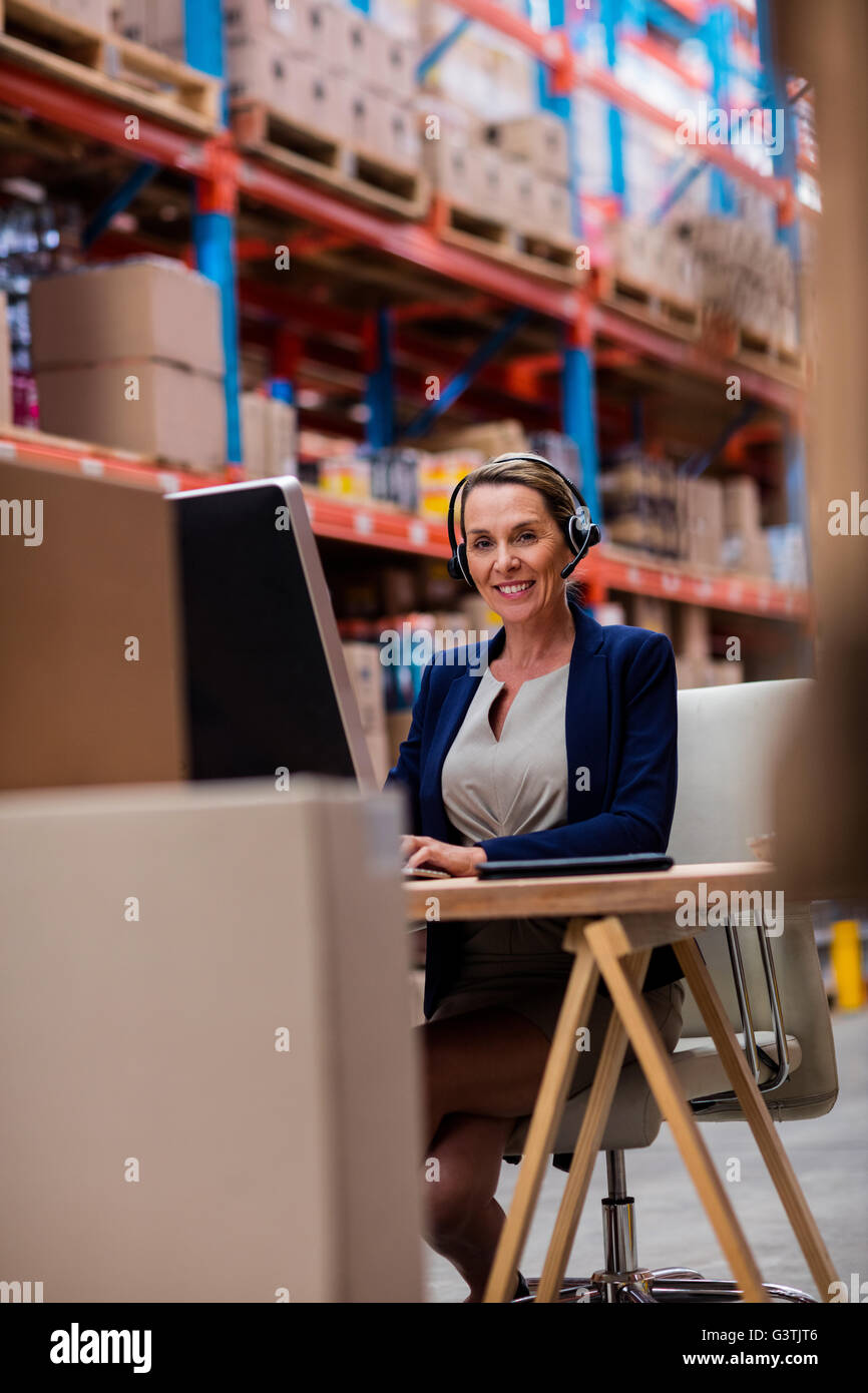 Portrait of warehouse manager working on her computer desk Stock Photo Alamy