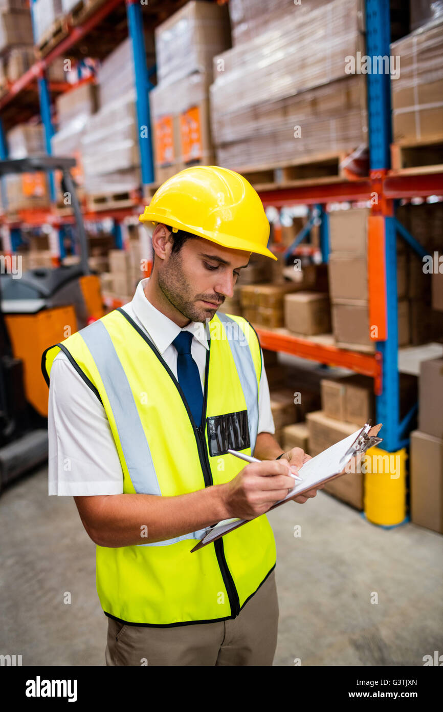 Warehouse manager checking list on his clipboard Stock Photo