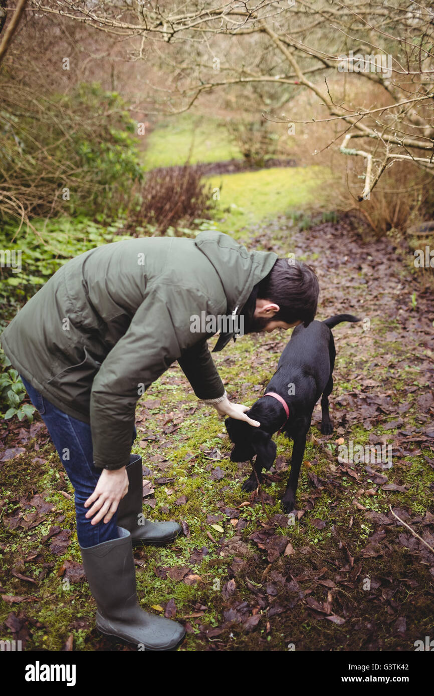 Attractive hipster man stroking his dog Stock Photo