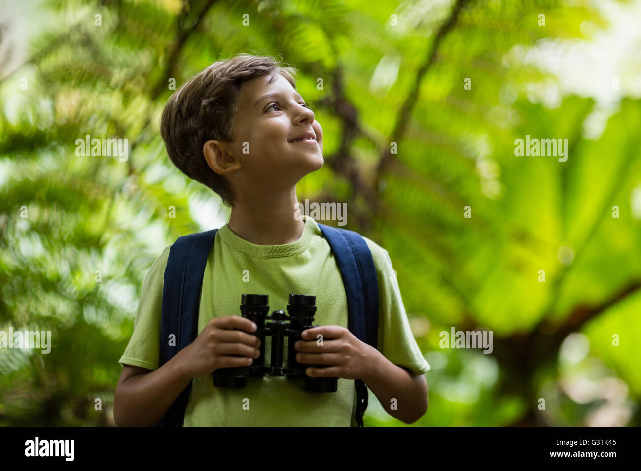 Happy boy holding binoculars Stock Photo