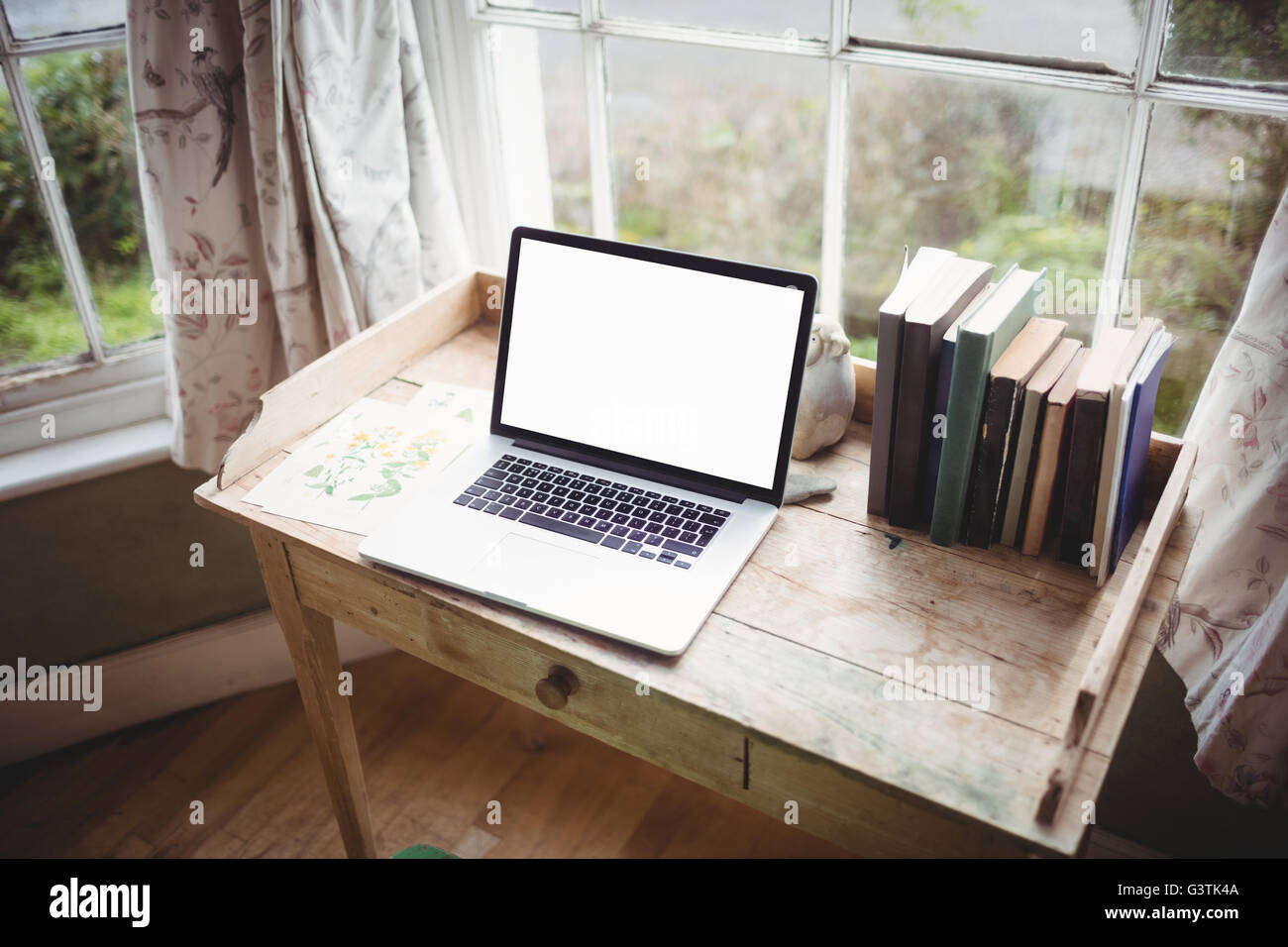 Close up view of wooden desk and laptop Stock Photo