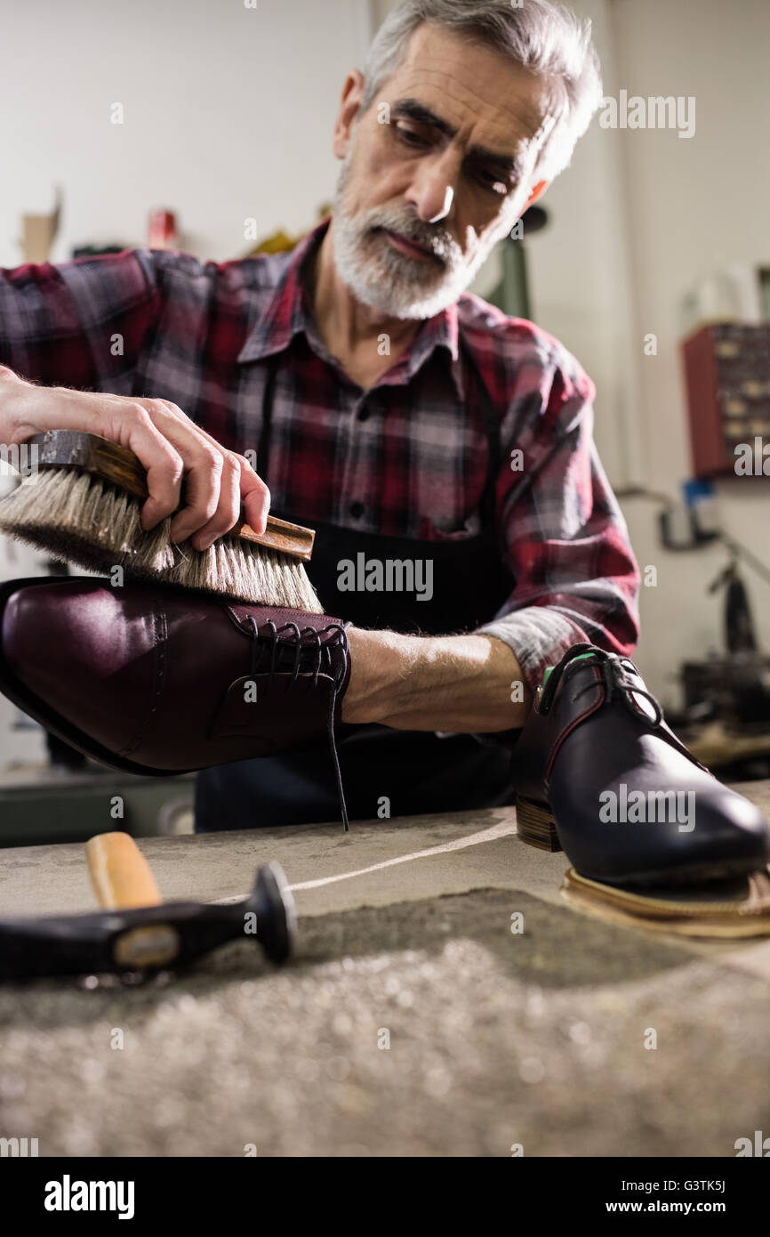 Portrait of cobbler polishing a shoe Stock Photo Alamy