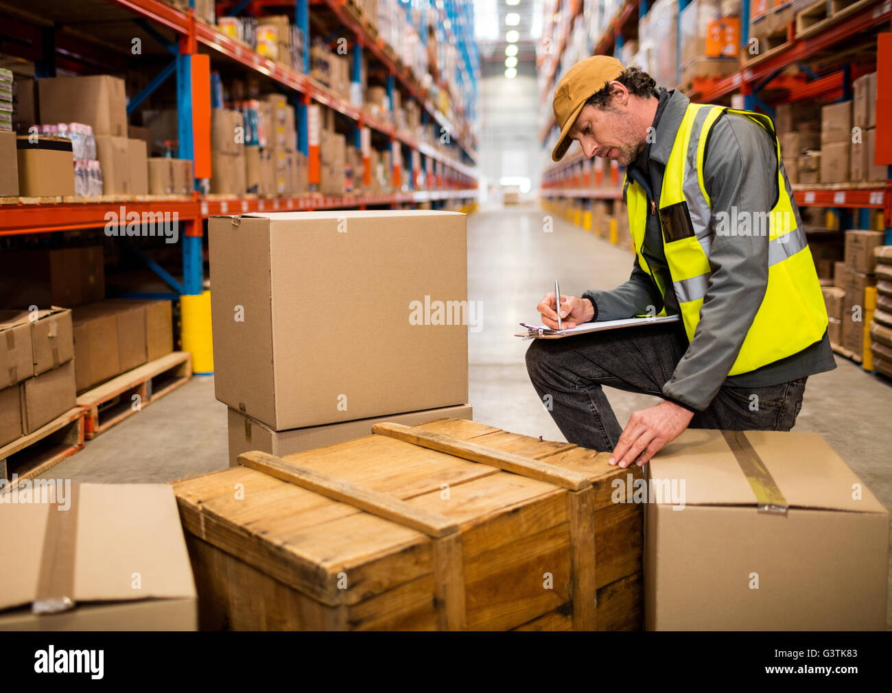 Warehouse worker checking his list on clipboard Stock Photo Alamy