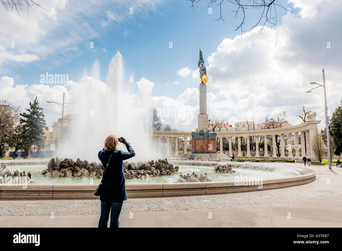 Austria, Vienna, Schwarzenbergplatz, Woman taking picture of statue Stock Photo