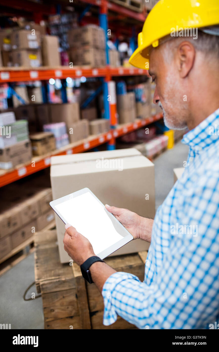 Warehouse worker using digital tablet Stock Photo Alamy