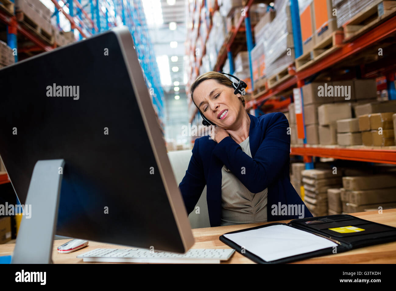 Warehouse manager with shoulder pain Stock Photo