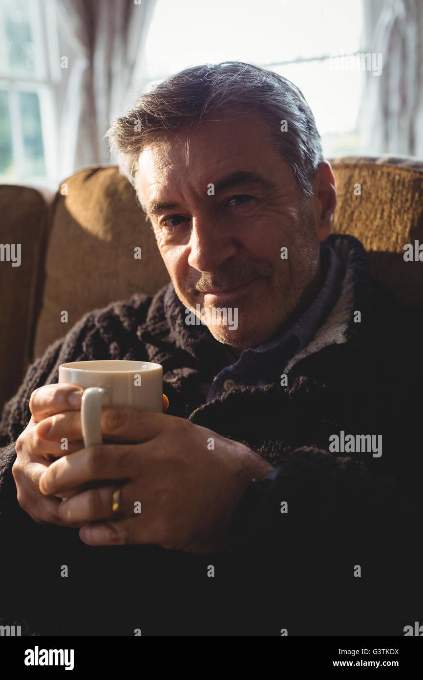 Portrait of man drinking cup of tea while relaxing Stock Photo