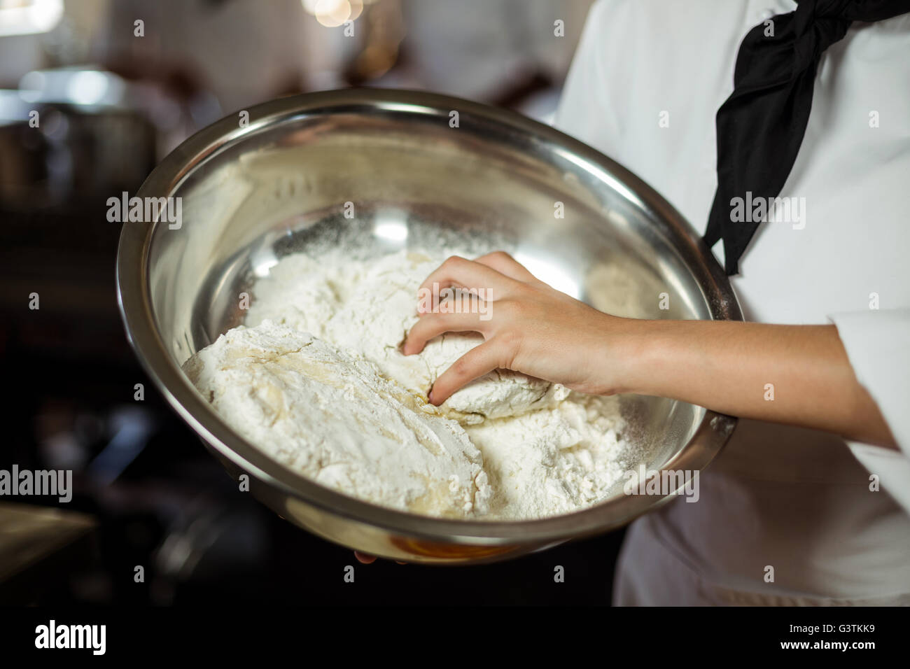 Mid section of head chef making pizza dough Stock Photo