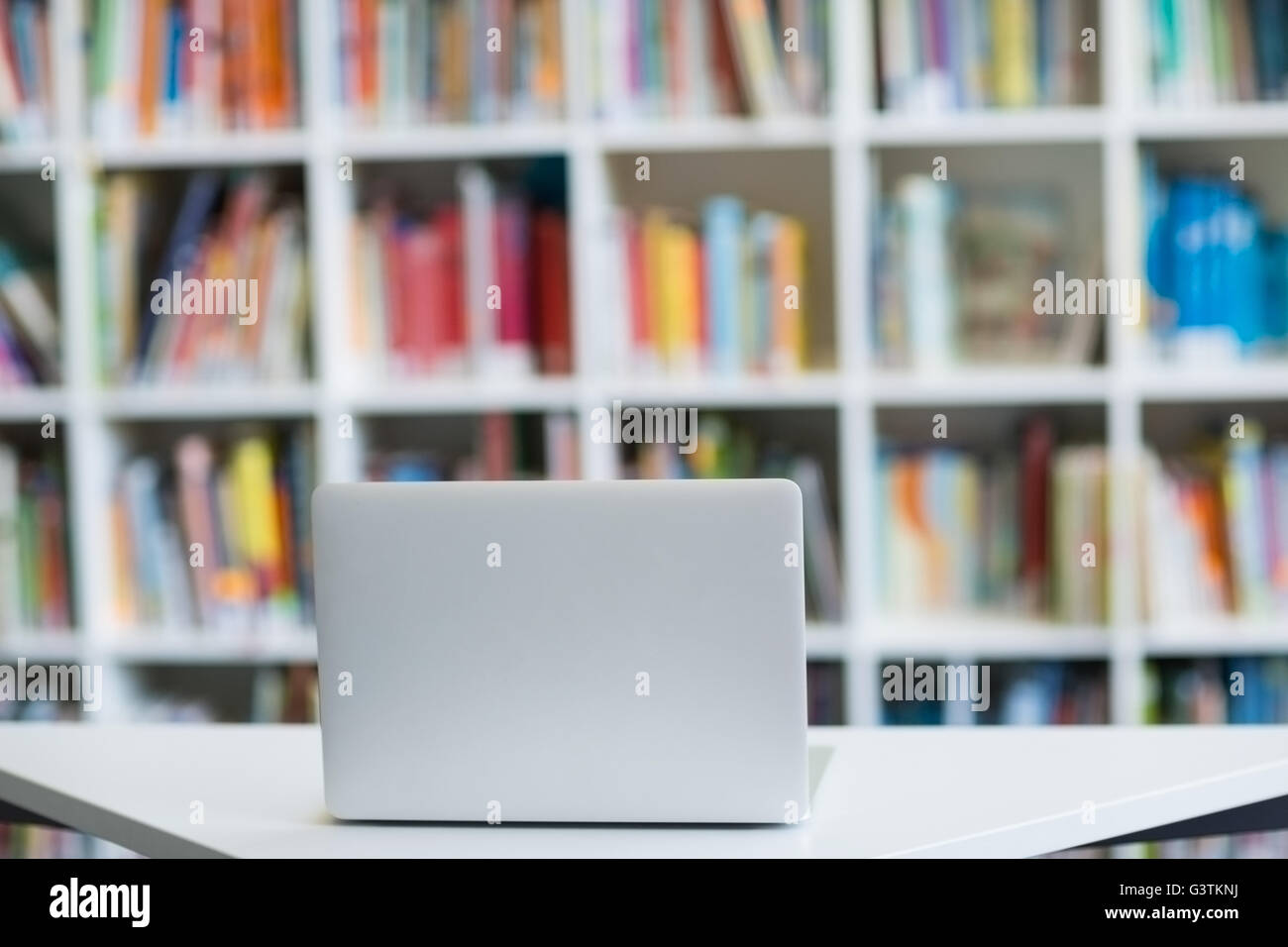 Laptop on table in library Stock Photo