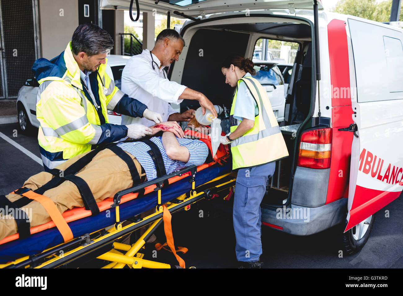 Doctor healing injured man Stock Photo