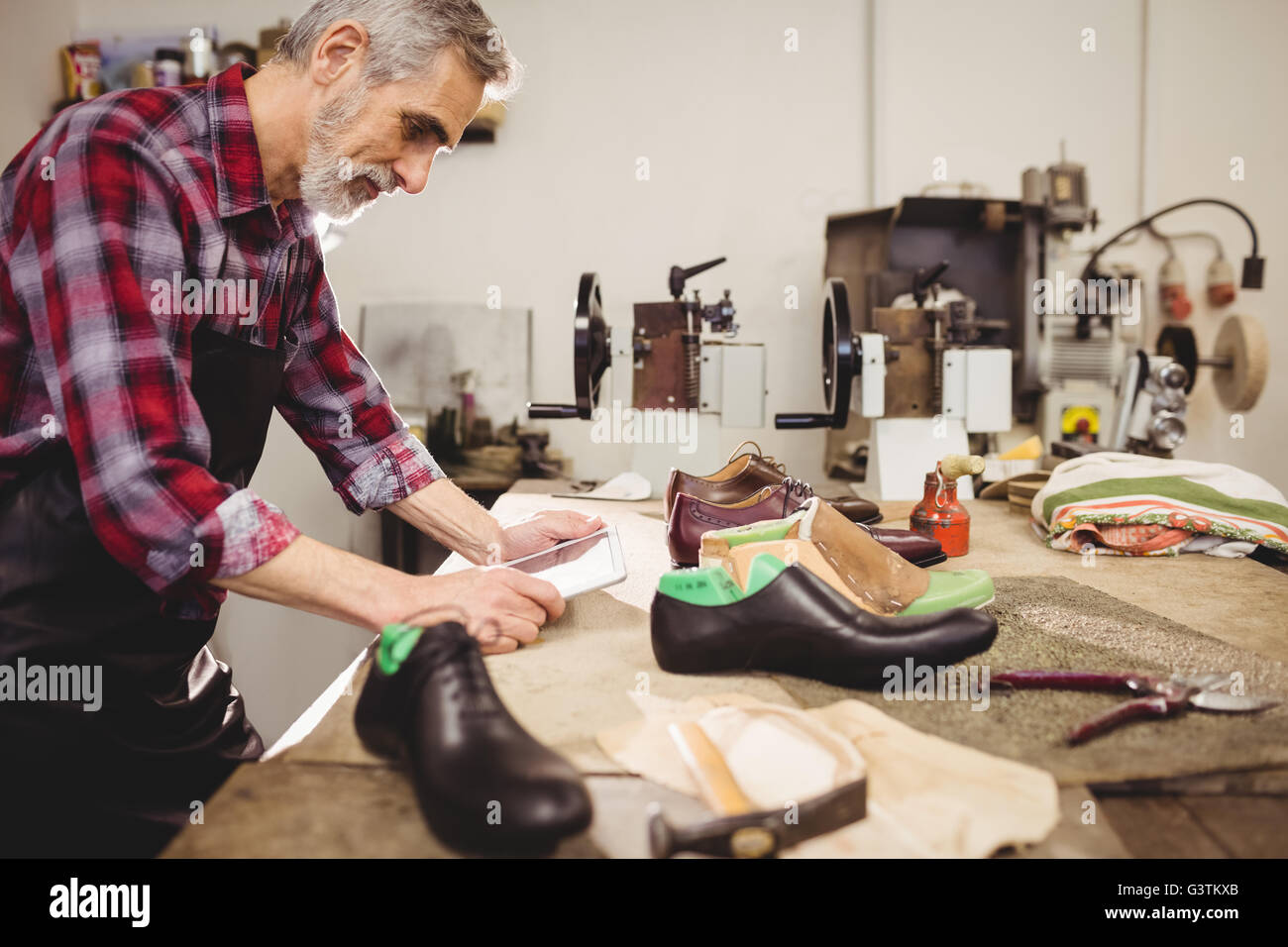 Concentrated cobbler working Stock Photo