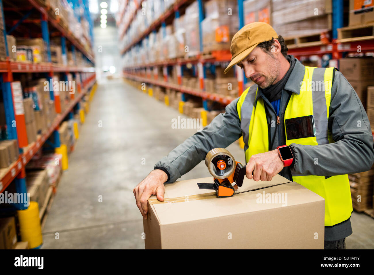 Man worker taping up a box Stock Photo