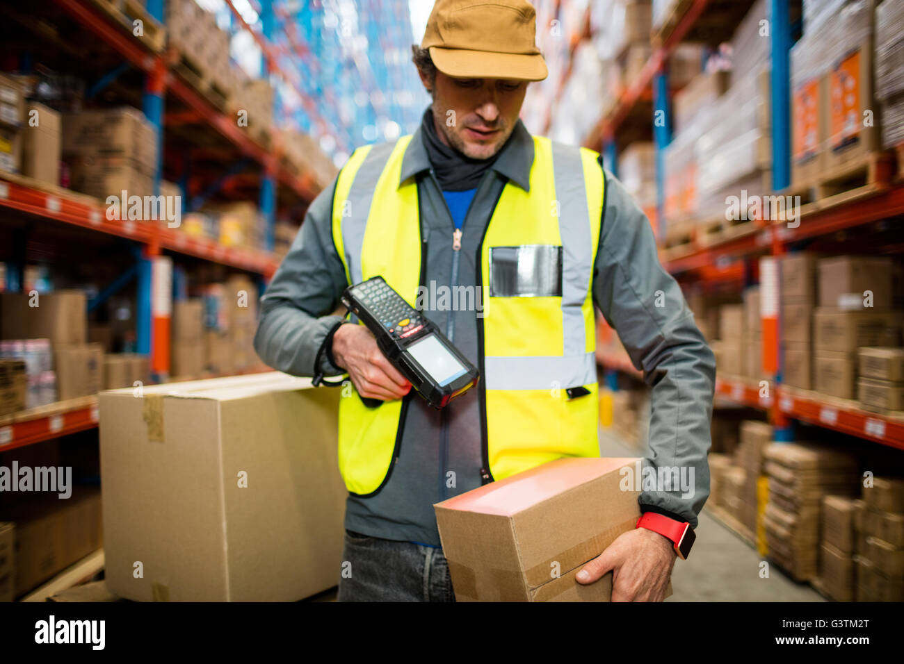 Warehouse worker using hand scanner Stock Photo - Alamy