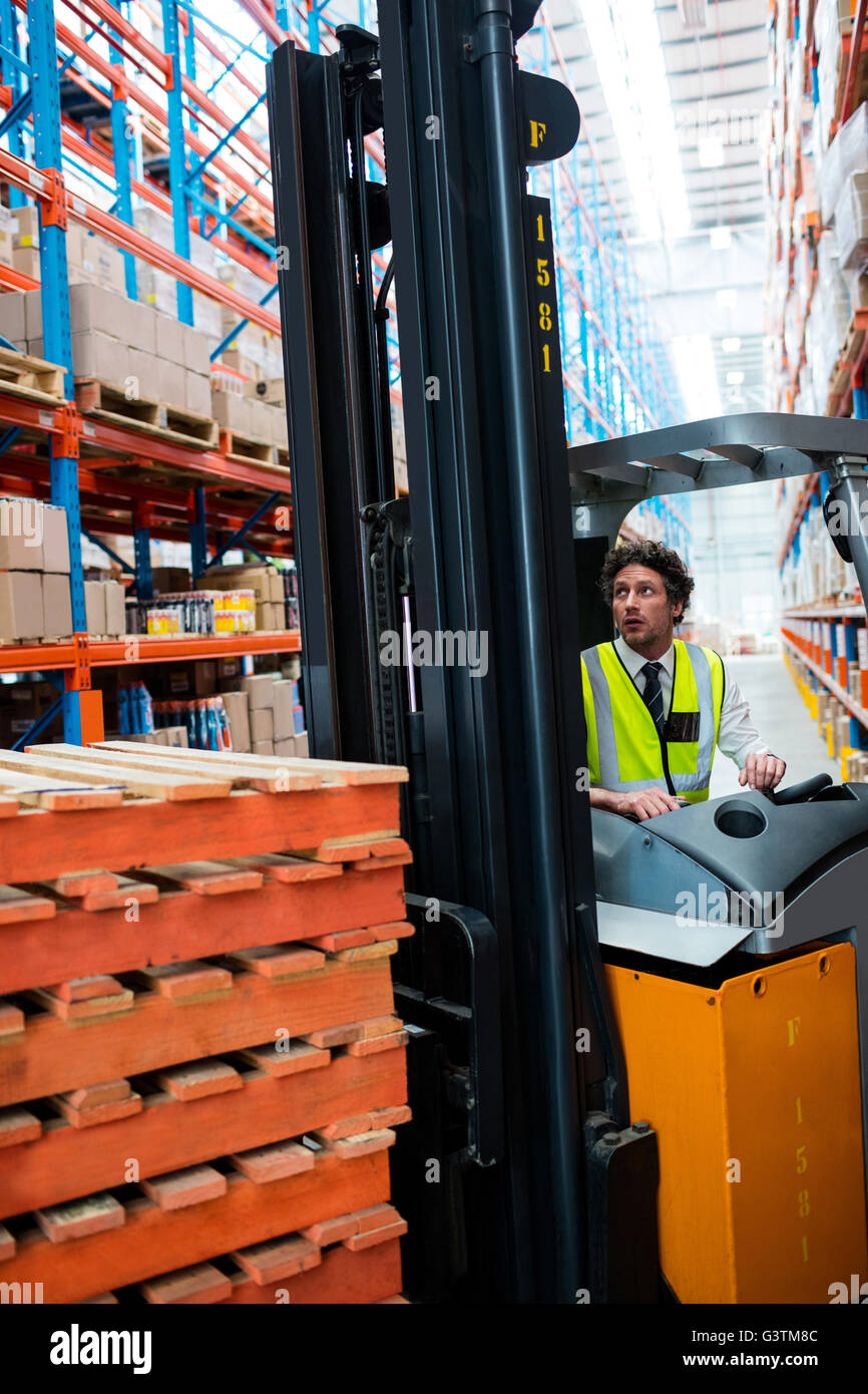 Warehouse manager using a forklift Stock Photo
