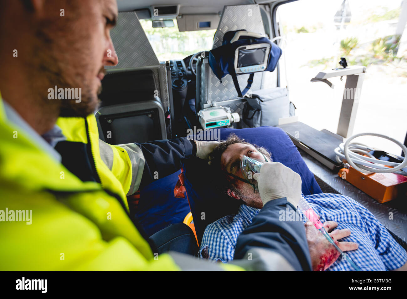 Injured man with ambulance man Stock Photo