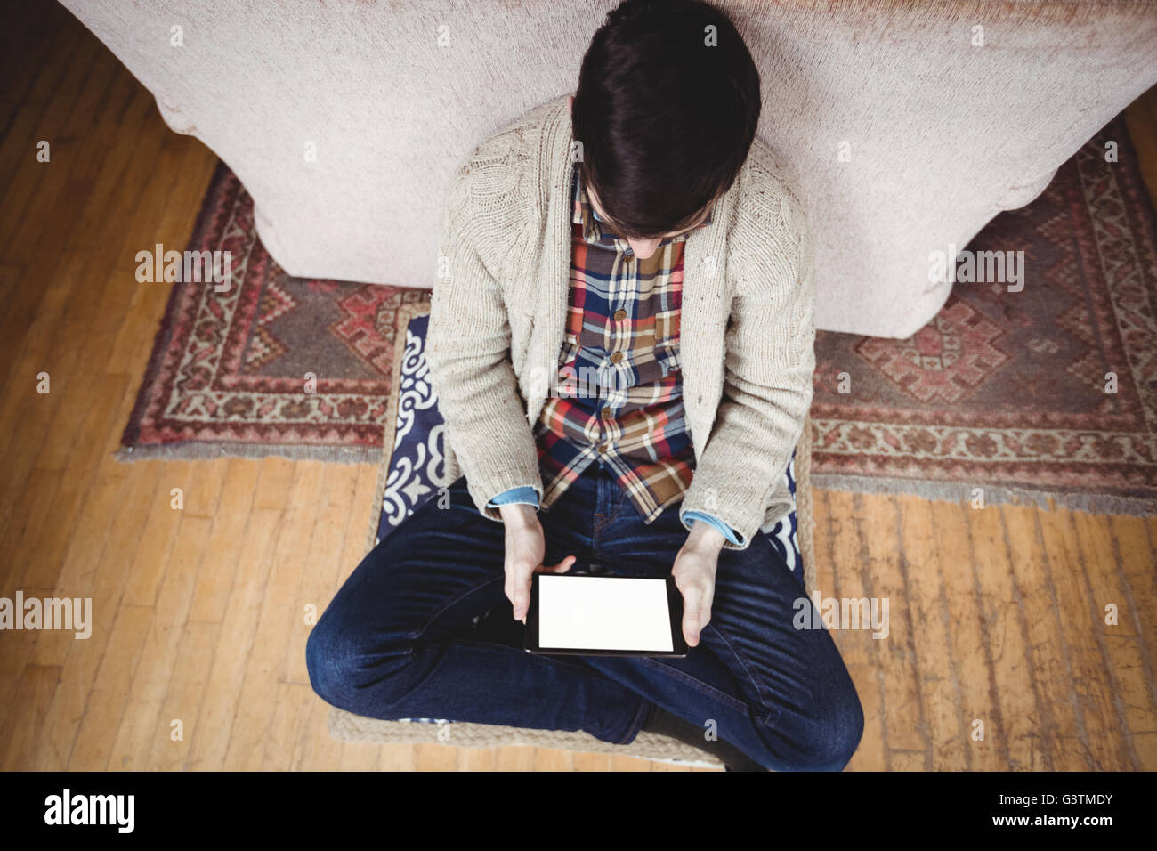 Hipster man using tablet computer while using tablet computer Stock Photo