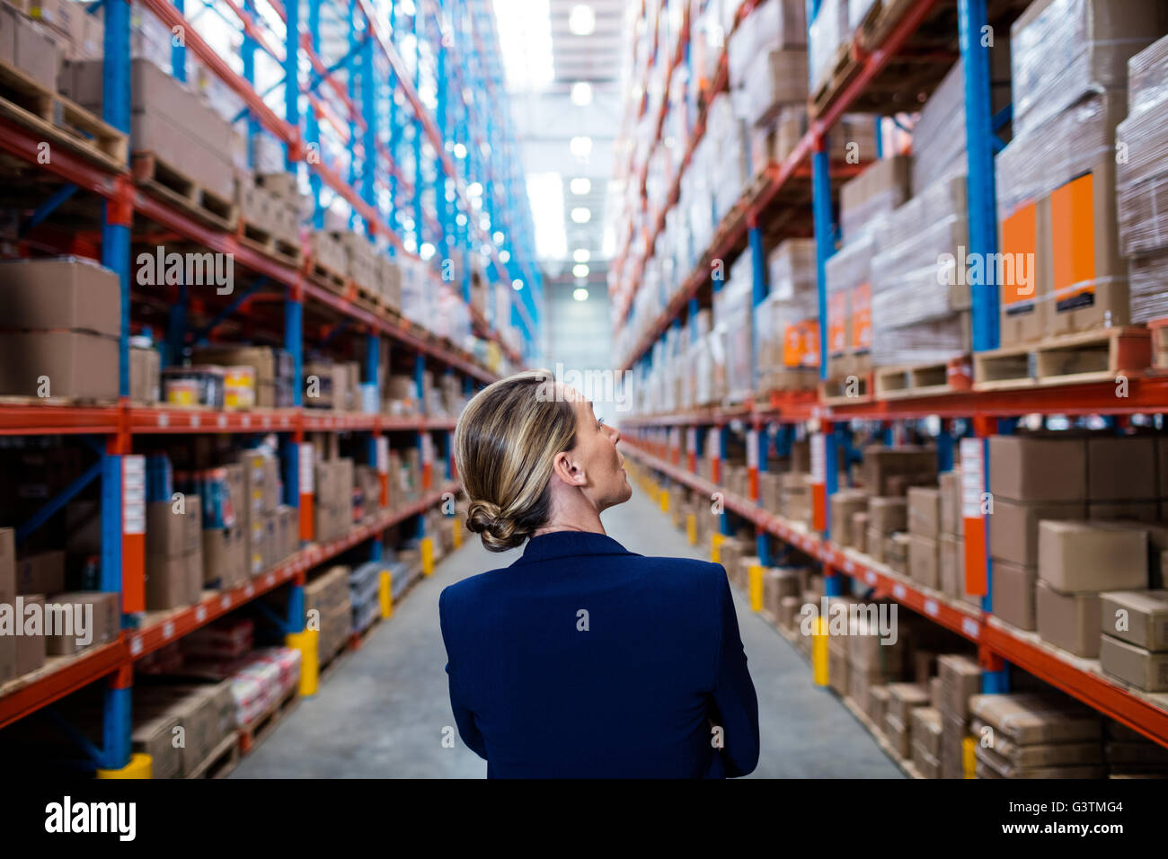 Rear view of warehouse manager walking Stock Photo