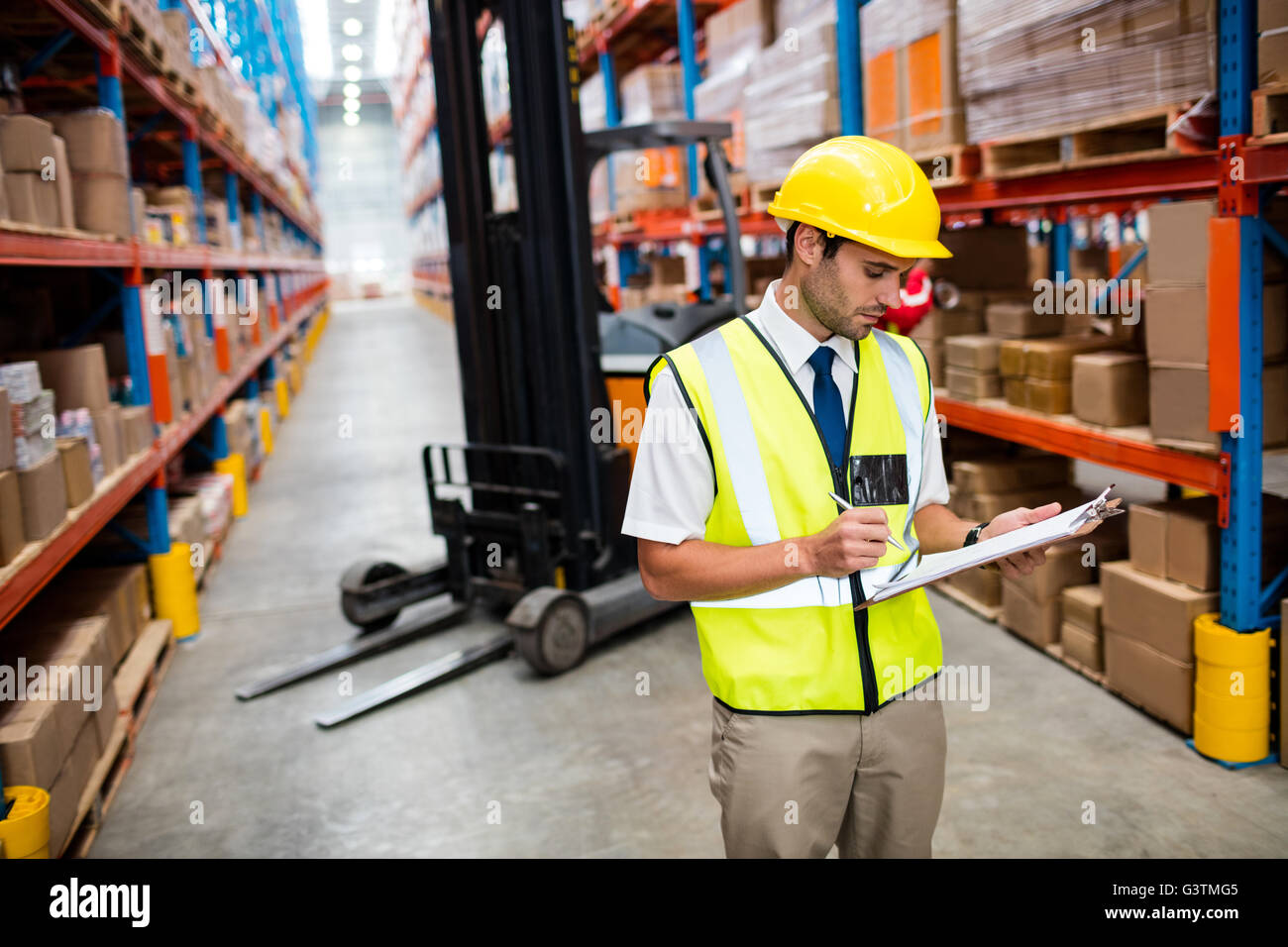 Warehouse manager checking list on his clipboard Stock Photo