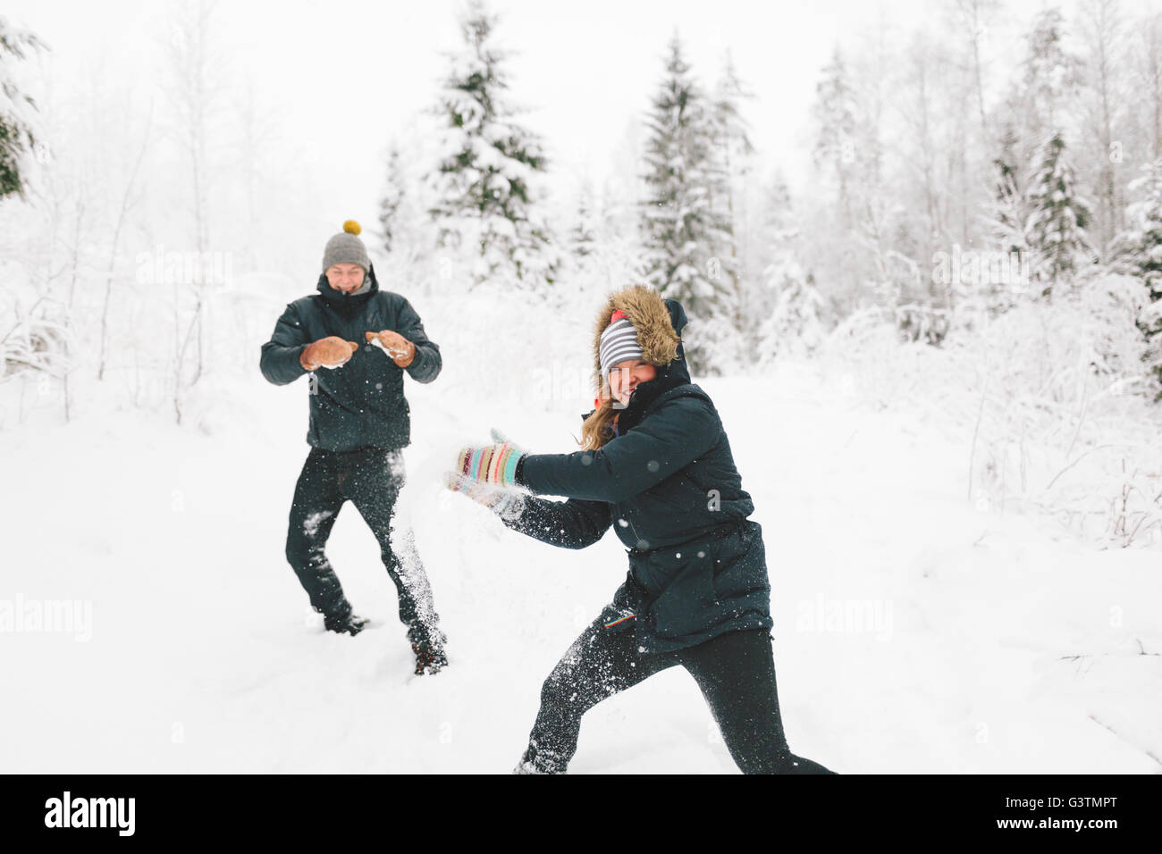 Young couple having snowball fight hi-res stock photography and images -  Alamy